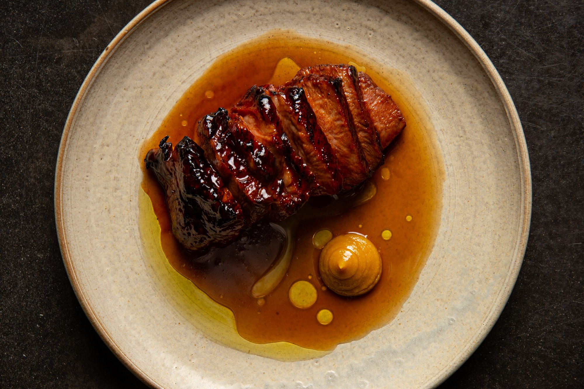 A plated dish at Poly on a dark background