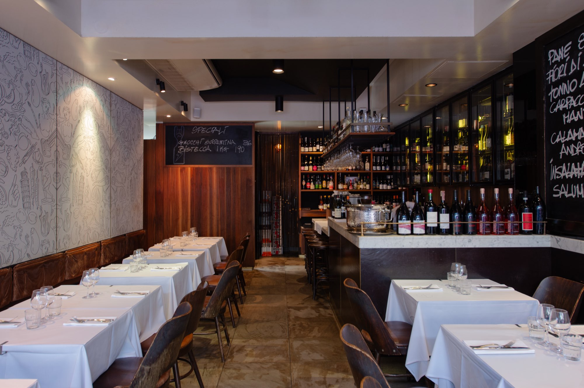White tablecloths in the dining room at Fratelli Paradiso, Sydney
