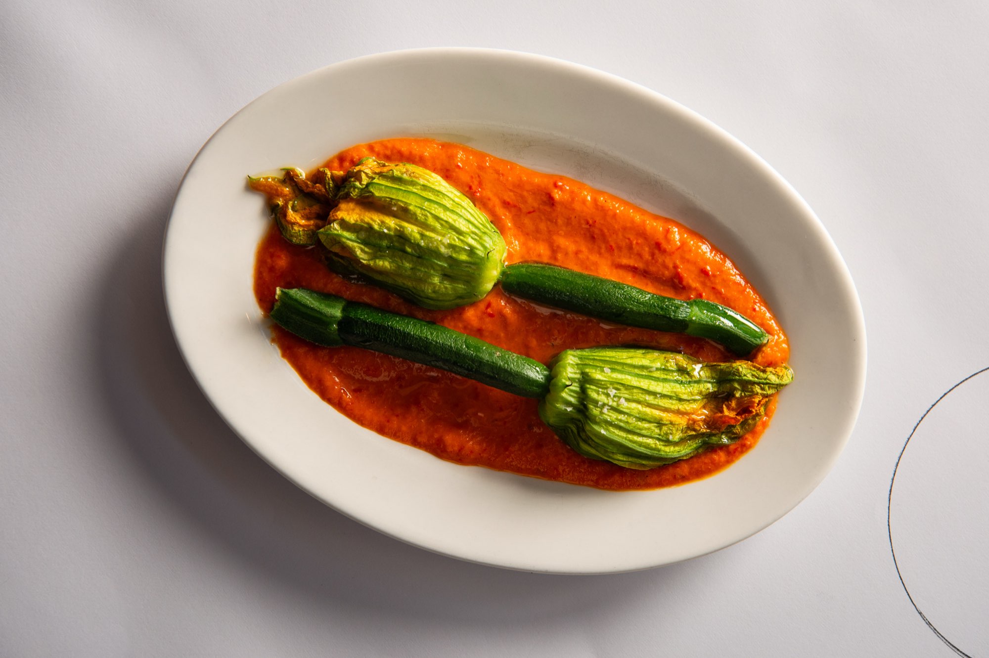 Zucchini flowers on a white plate at Fratelli Paradiso